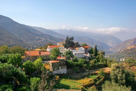 View of Kefali village, Chania. A picturesque settlement, surrounded by mountainsides and hills with dense vegetation.