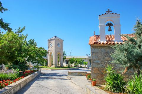 A stone built chapel and beautiful flowers in Anogia village