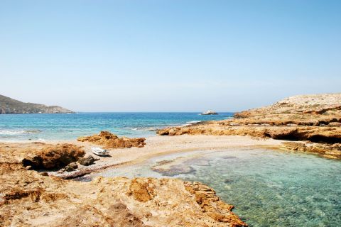 Koumbara beach, Ios. Relax on the soft golden sand and enjoy the shallow waters of this beautiful bay.