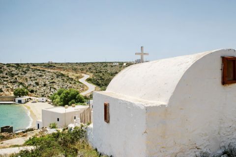 A whitewashed chapel, overlooking the hills.