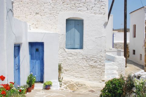 Some whitewashed buildings and blue-colored windows and doors