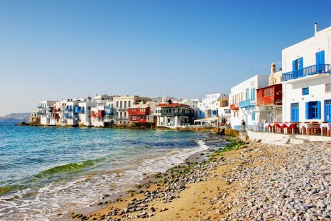 Crystal clear waters and cycladic buildings by the sea