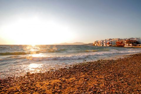 Sunset view from a lovely beach on Mykonos island.