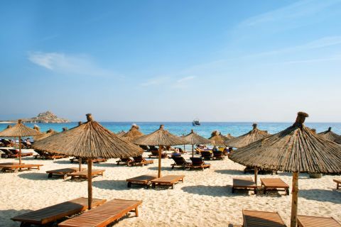 Umbrellas and sun loungers on Platis Gialos beach.