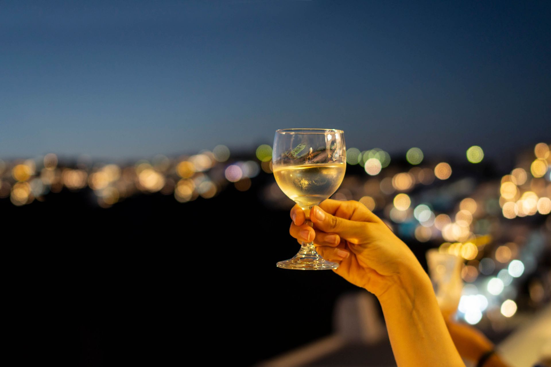 Drinking wine on the edge of the Caldera of Santorini