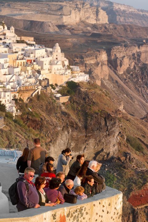 Many tourists gather in Oia to see the breathtaking sunset.