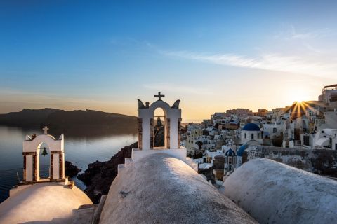 The belfry of a whitewashed church in Santorini