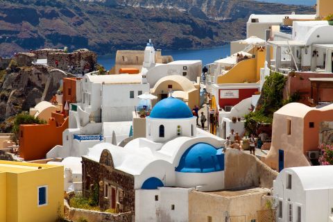 The blue-domed church of Panagia stands out among other buildings in Oia.