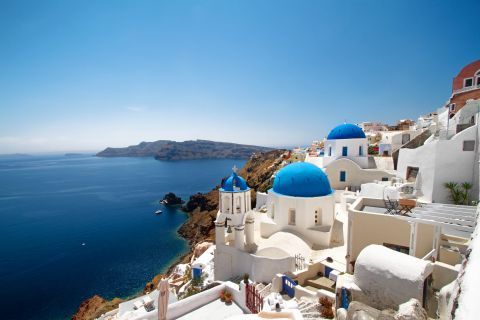 The blue-domed churches of Santorini and their sharp color contrast