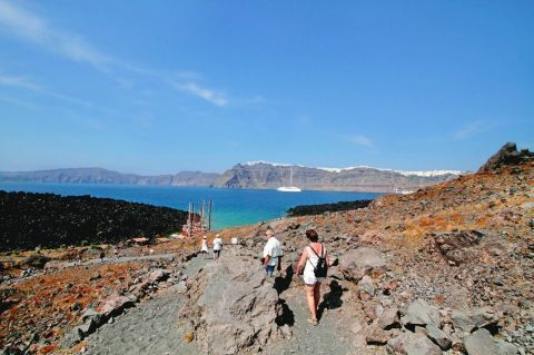 Visiting the active volcano with view over the villages of the caldera