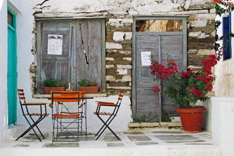 Stone-built constructions with wooden doors and colorful flowers are spotted averywhere around Pyrgos village.