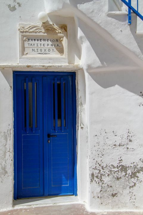A traditional kafenio in Isternia village. It is housed in a nice building, painted in white and blue colors.