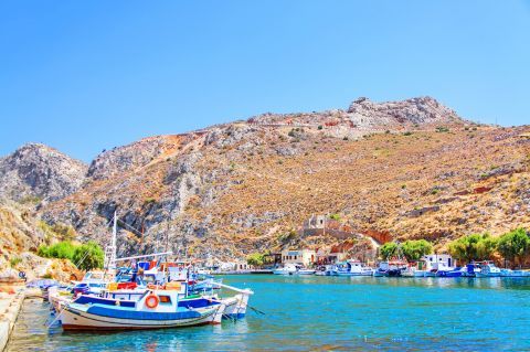 Fishing boats, mooring on the picturesque harbor of Rina beach, Kalymnos