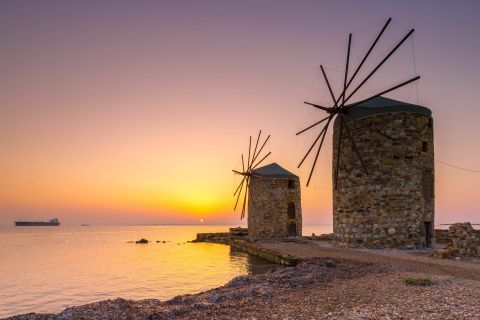 Sunset time and traditional windmills in Chios.