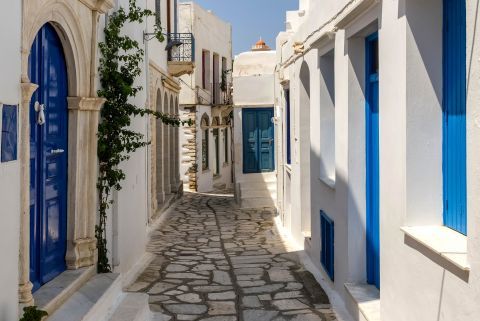A cobblestone pavement and Cycladic houses in Tinos.
