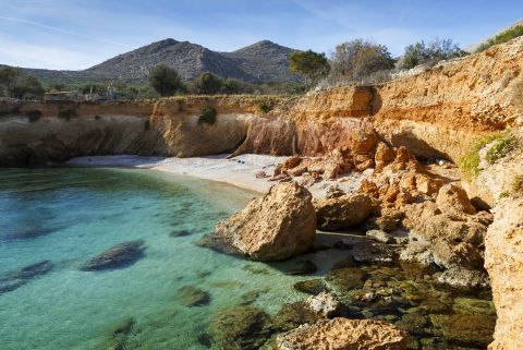 An isolated, rocky beach with turquoise waters, Chalki.