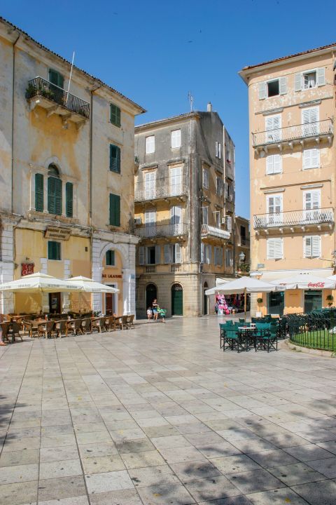 A central square with cafes and restaurants in Corfu Town.
