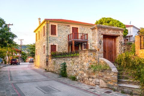 A stone built house with wooden details in Nikiti village, Halkidiki.