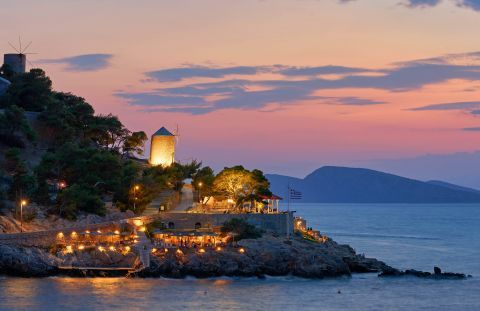 A beautiful spot with windmils in Hydra during sunset time