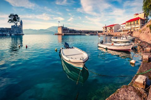 Small, fishing boats, mooring on the blue waters of Nafpaktos