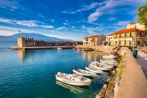 Small, fishing boats, mooring on the blue waters of Nafpaktos