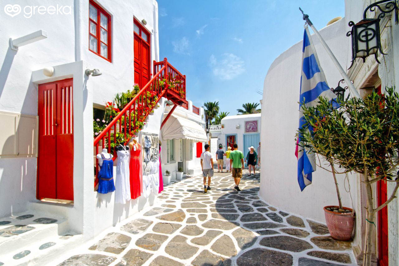 Island hopping to Mykonos and stroll around the beautiful town