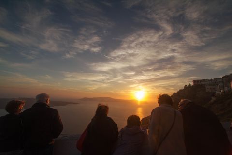 Sunset: Tourists admiring the sunset in Santorini