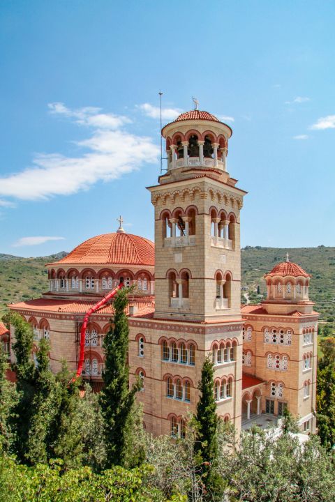 Agios Nektarios Monastery: The church has two high bell towers and four series of windows, all covered with red bows.