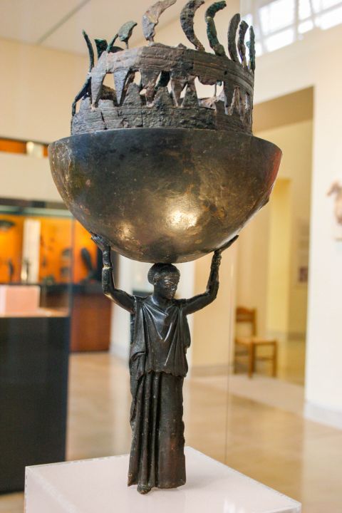 Archaeological Museum: A bronze incense-burner in the form of a peplophoros, a female figure holding above her head a cauldron for burning the incense.