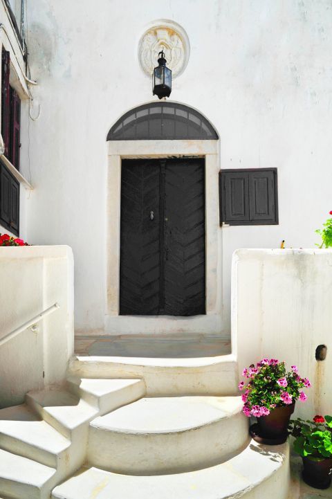 Kastro (Castle): A white building with a dark-colored door