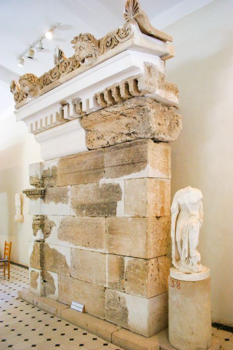Archaeological Museum: A part of a ruined wall and a marble sculpture of a woman body.