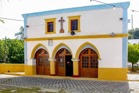 Asomatos: A local church, painted in light colors.