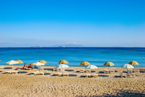 Lagades: Umbrellas and sun loungers on Lagades beach.