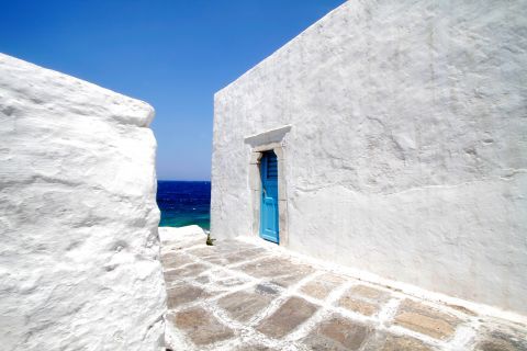 Town: A whitewashed building with a blue-colored door