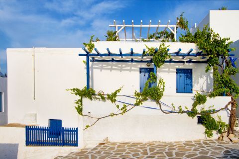 Parikia: A whitewashed house with blue-colored details
