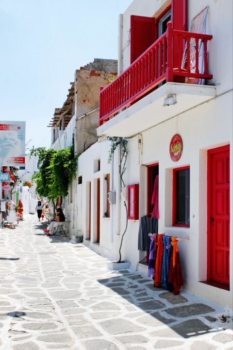 Naoussa: A whitewashed building with red-colored details