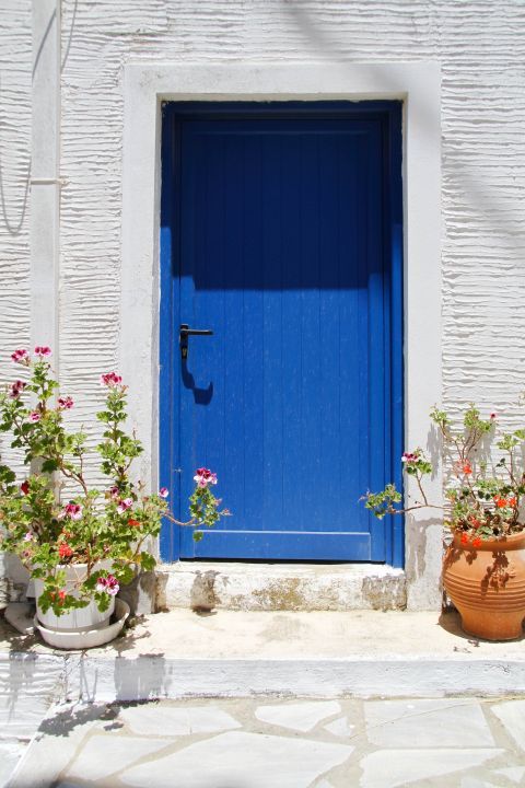 Kambos: A blue door and lovely flower pots