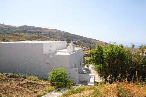 Tripotamos: A whitewashed building, surrounded by lush vegetation