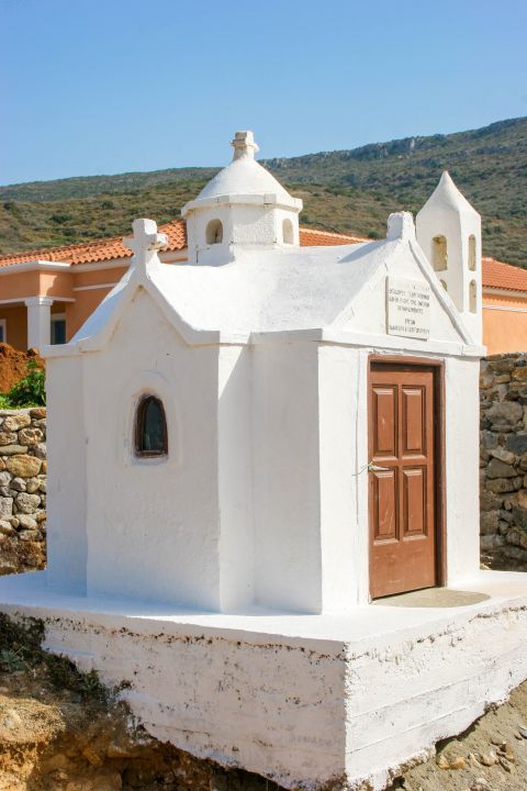 Agia Pelagia beach: A whitewashed chapel with a wooden door.
