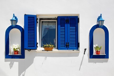 Marmara: Blue colored windows of a whitewashed house