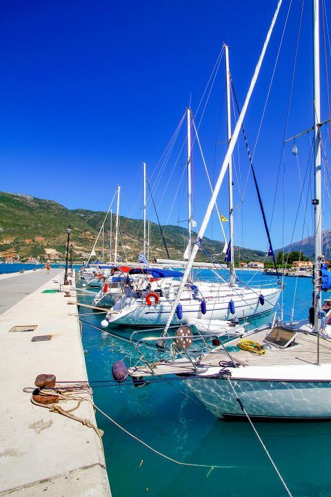 Vassiliki village: Yachts, sailing boats and fishng boats moor on the harbor of Vassiliki.