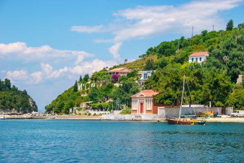 Lakka: Hills with dense vegetation and colorful houses, overlooking the blue waters of the Ioanian.