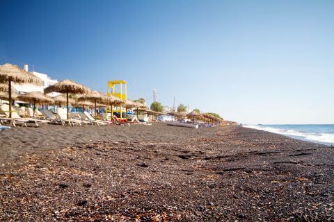 Kamari: The black sand of Kamari beach