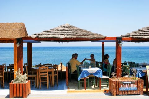 Perissa: A restaurant with tables close to the sea