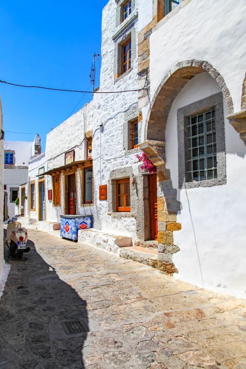 Chora: Whitewashed buildings with wooden details.