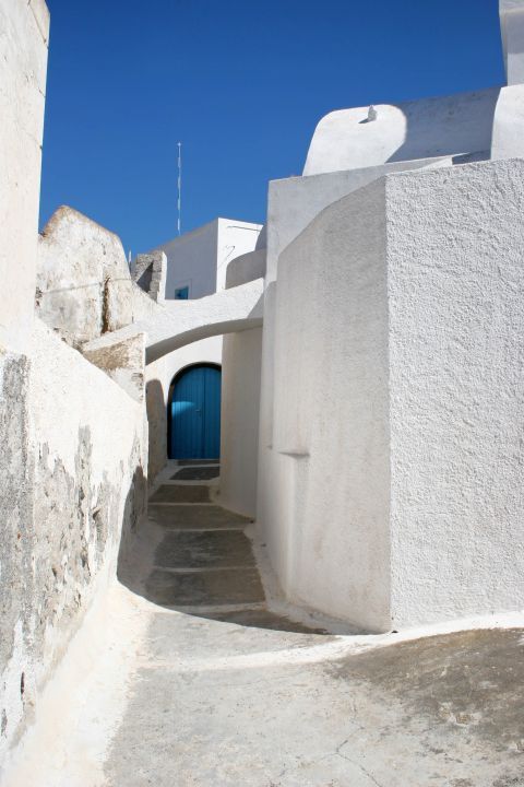 Messaria: A whitewashed building with a blue-colored door