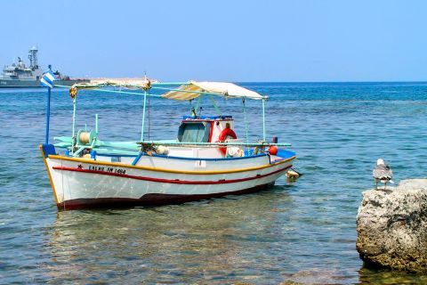 Myrina beach: A small, fishing boat.