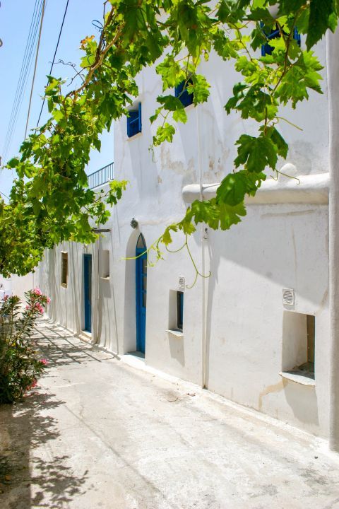 Chora: A white colored house with blue shutters and doors.
