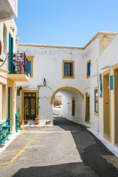 Chora: Two-floored buildings in white, blue and yellow colors.