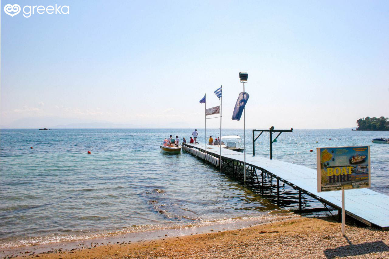 A small, boat-hiring dock in Dassia Beach, Corfu